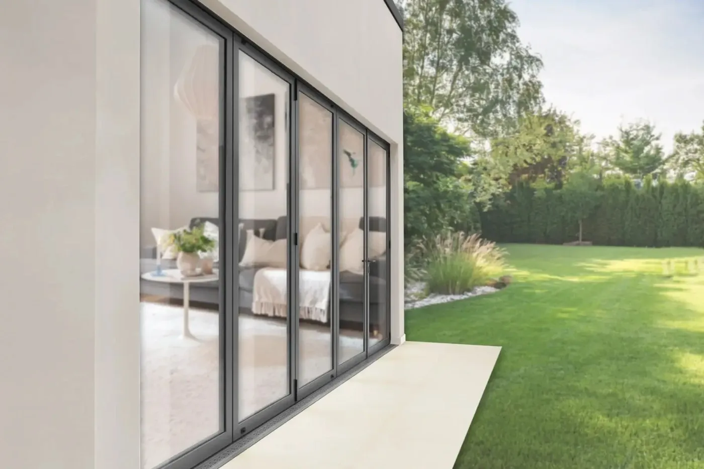Aluprof aluminium bifold doors folded open onto a garden